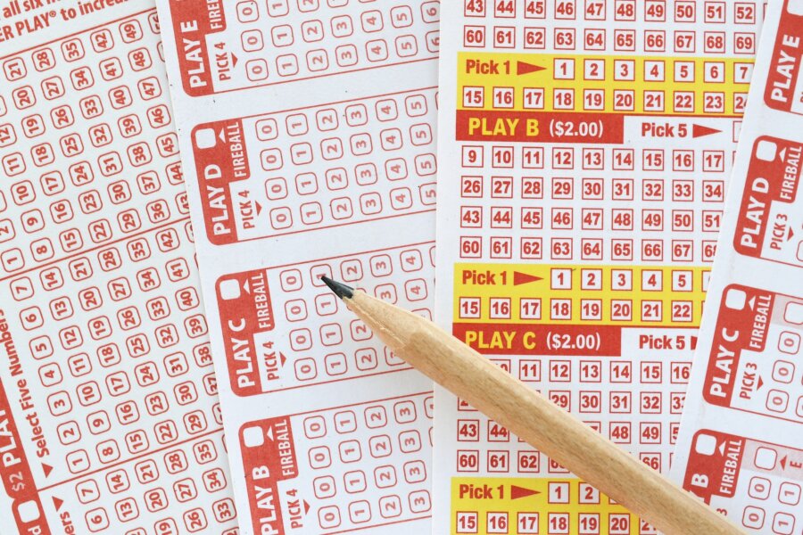lottery ticket sheets with numbers and pencil